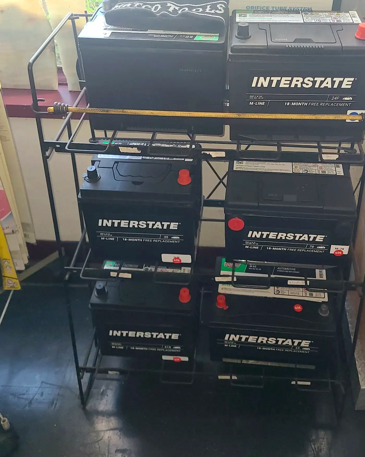 A rack of Interstate batteries in the front office at Beach Motor & Tires