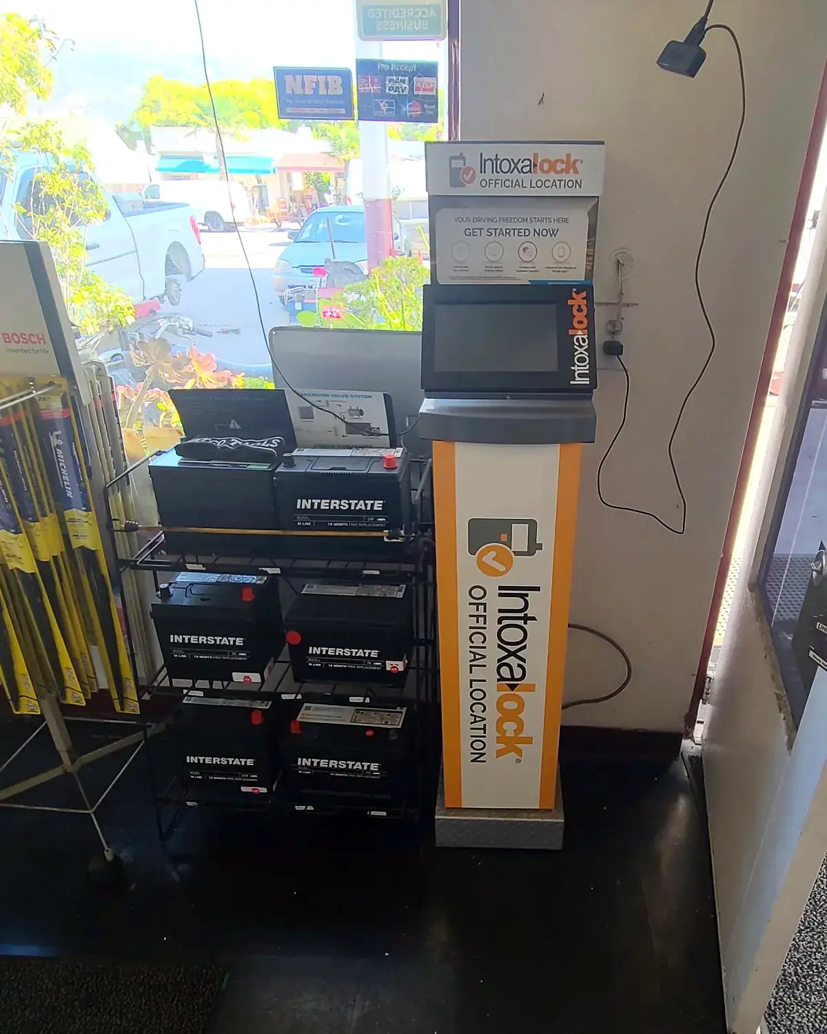 The Intoxalock official location kiosk beside the Interstate battery rack in the front office
