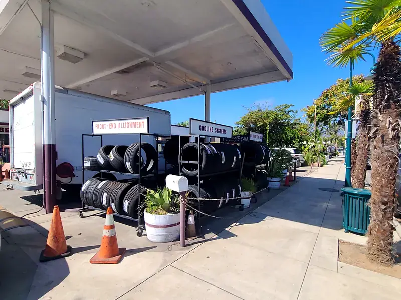 Racks of new tires under the canopy out front at Beach Motor & Tires, Carpinteria Ave