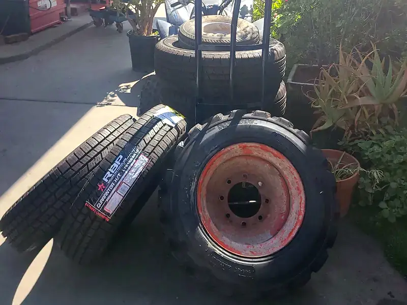 Tires for a loader, a truck and a trailer beside the tire machine